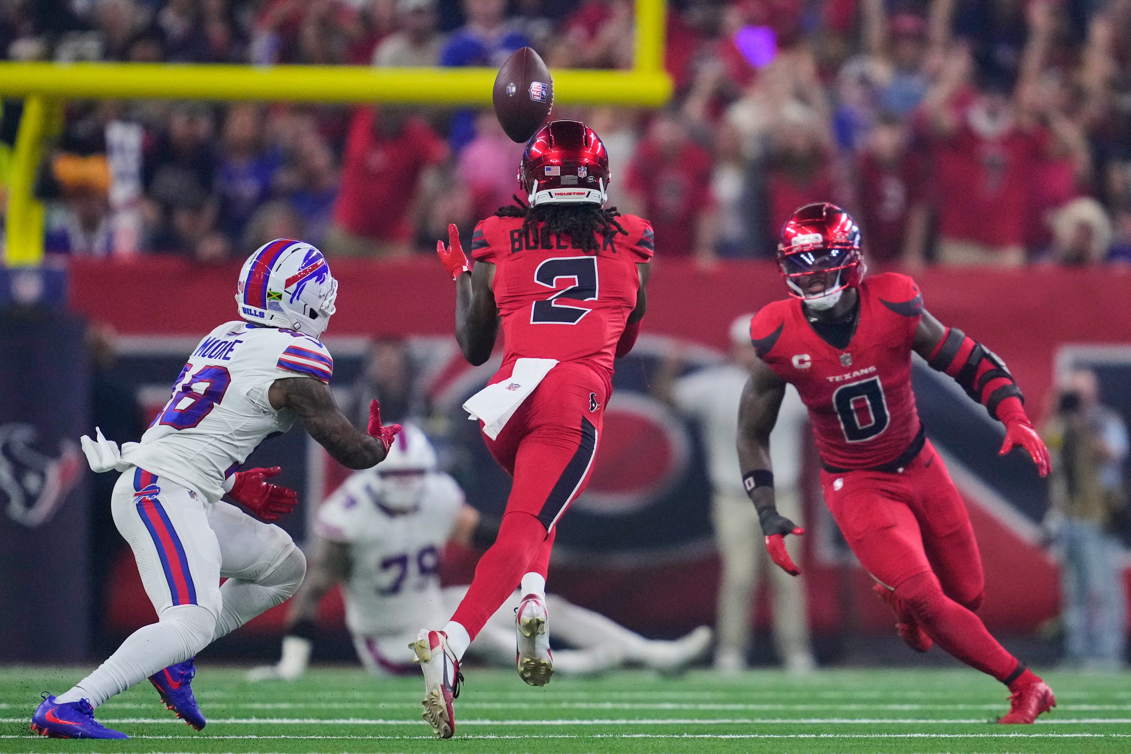 Houston Texans safety Calen Bullock (2) intercepts a pass intended for Buffalo Bills' Elijah Moore (18) as Azeez Al-Shaair (0) looks on in the first half of an NFL football game Thursday, Nov. 20, 2025, in Houston. (AP Photo/Ashley Landis)