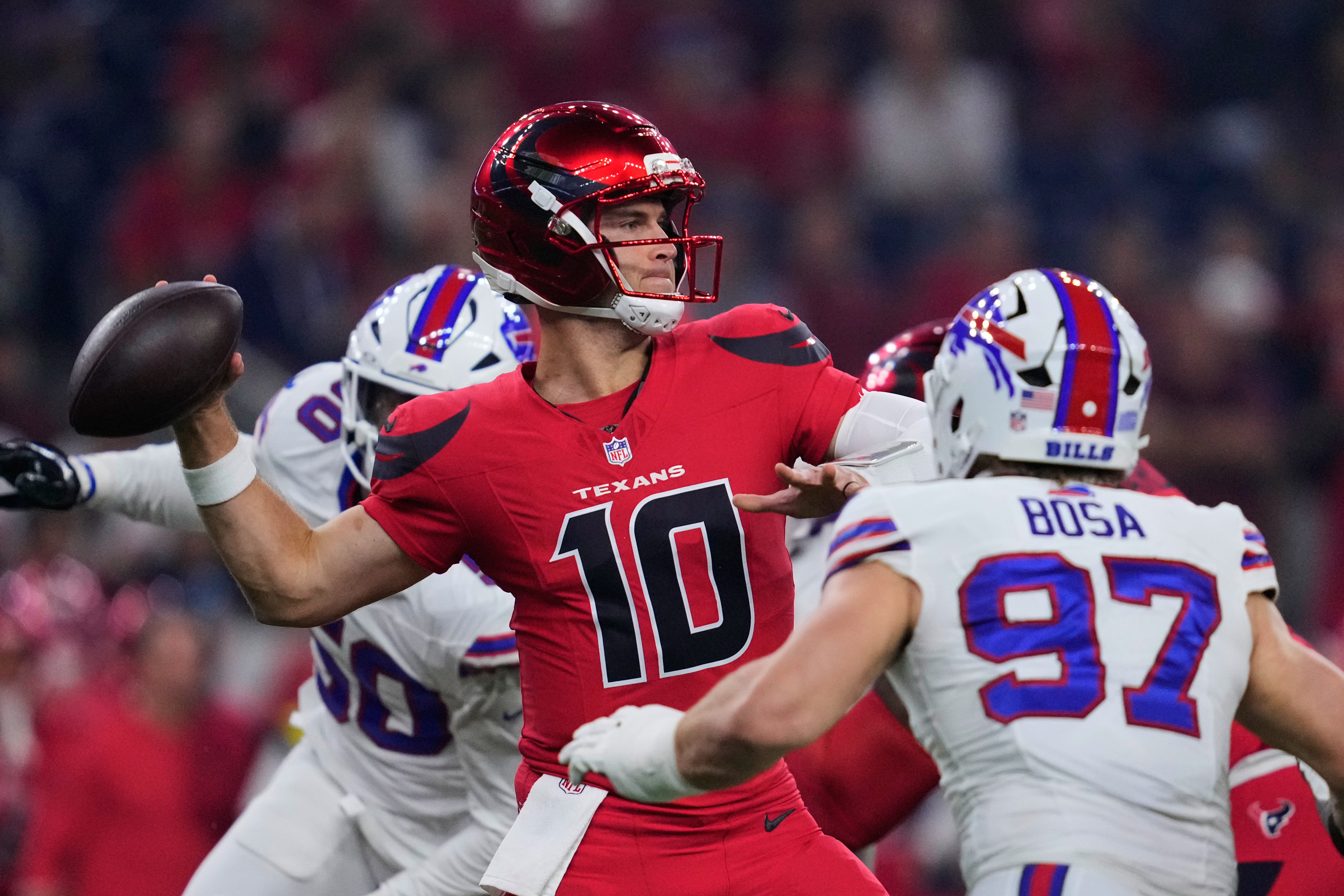 Houston Texans quarterback Davis Mills (10) throws a pass under pressure from Buffalo Bills defensive end Joey Bosa (97) in the first half of an NFL football game Thursday, Nov. 20, 2025, in Houston. (AP Photo/Ashley Landis)