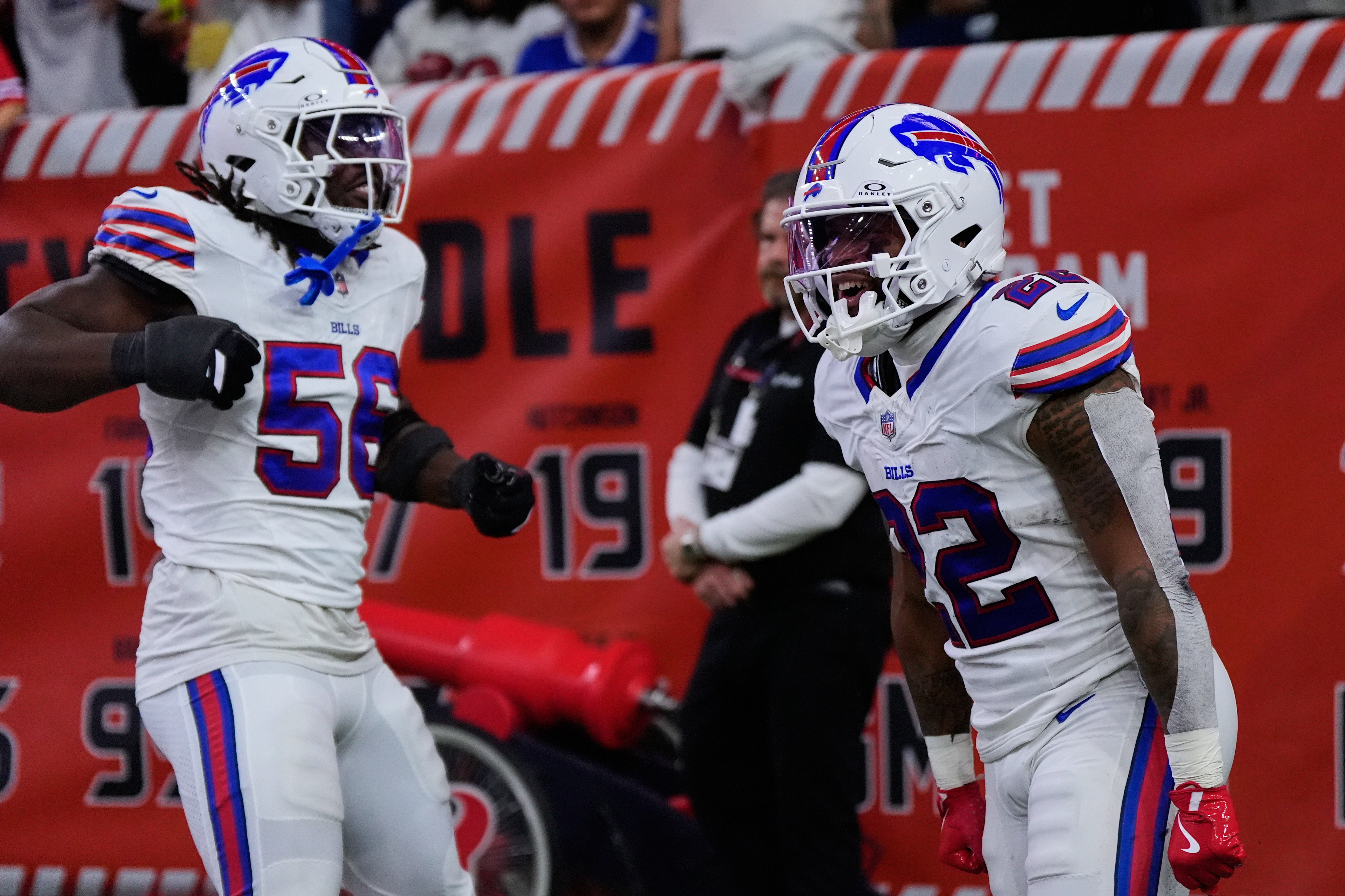 Buffalo Bills' Javon Solomon (56) and Ray Davis (22) celebrate after Davis returned a kick-off for a touchdown in the first half of an NFL football game against the Houston Texans Thursday, Nov. 20, 2025, in Houston. (AP Photo/Ashley Landis)