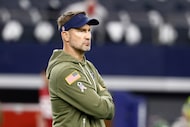 Dallas Cowboys head coach Brian Schottenheimer stands on the field before a NFL game against...