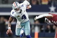 Dallas Cowboys quarterback Dak Prescott (4) scrambles away from the Arizona Cardinals...
