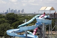 People wait in line to slide down a waterslide at Bahama Beach Waterpark in Dallas' Redbird...