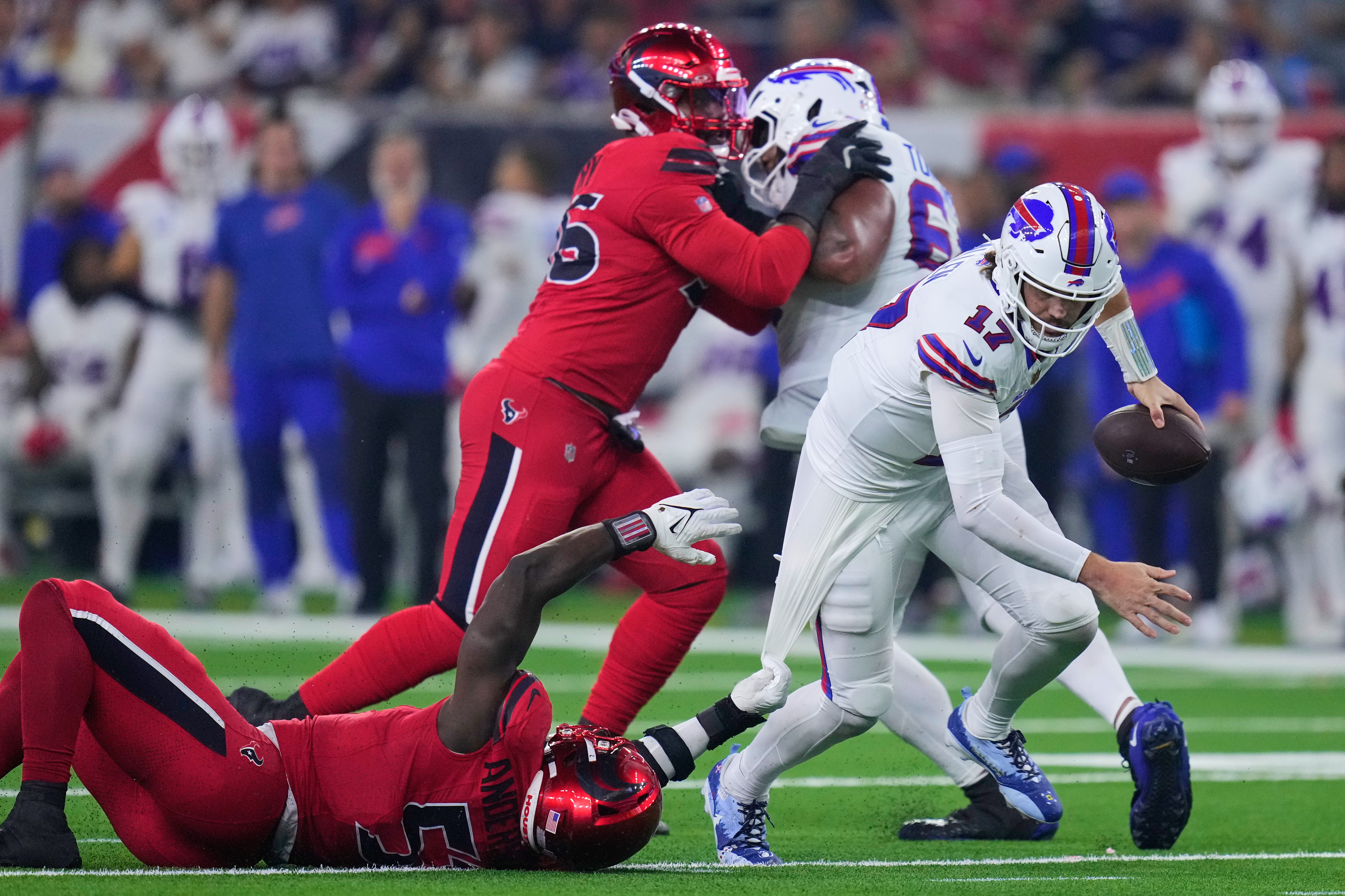 Buffalo Bills quarterback Josh Allen (17) escapes the grasp of Houston Texans defensive end Will Anderson Jr. (51) in the second half of an NFL football game Thursday, Nov. 20, 2025, in Houston. (AP Photo/Eric Christian Smith)