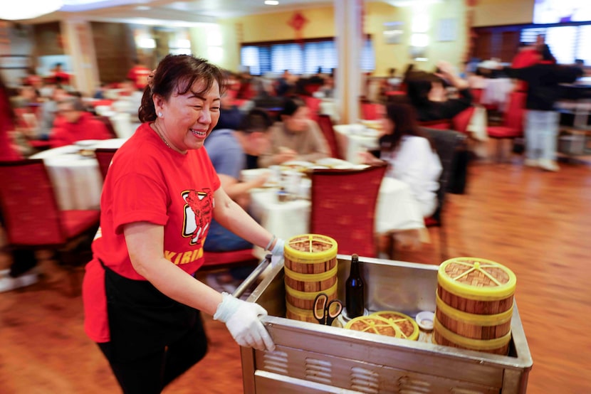 Kirin Court employee Kim Wang pushes a cart on through the Richardson dining room.