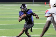 North Forney High QB Legend Bey (7) looks for an opening through the Skyline High defense...