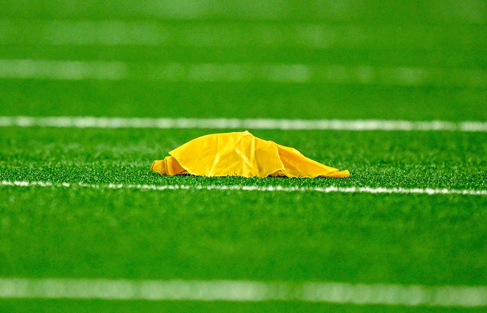 Sep 28, 2025; Arlington, Texas, USA; A view of a yellow penalty flag during the game between the Dallas Cowboys and the Green Bay Packers at AT&T Stadium.