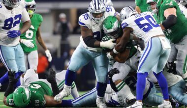 Nov 23, 2025; Arlington, Texas, USA; Philadelphia Eagles running back Saquon Barkley (26) is tackled by Dallas Cowboys defensive tackle Kenny Clark (95) in the third quarter at AT&T Stadium.