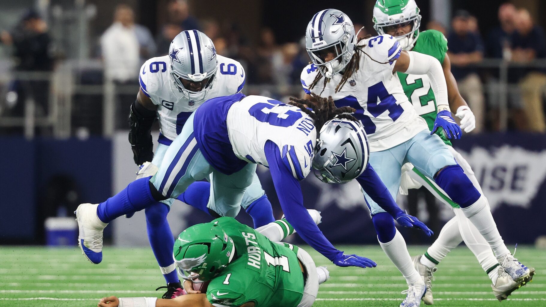 Nov 23, 2025; Arlington, Texas, USA; Philadelphia Eagles quarterback Jalen Hurts (1) slides with the ball in the third quarter against the Dallas Cowboys at AT&T Stadium.
