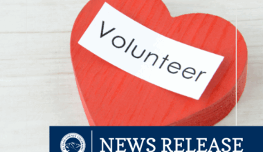 News Release graphic featuring a red heart with the word "Volunteer"