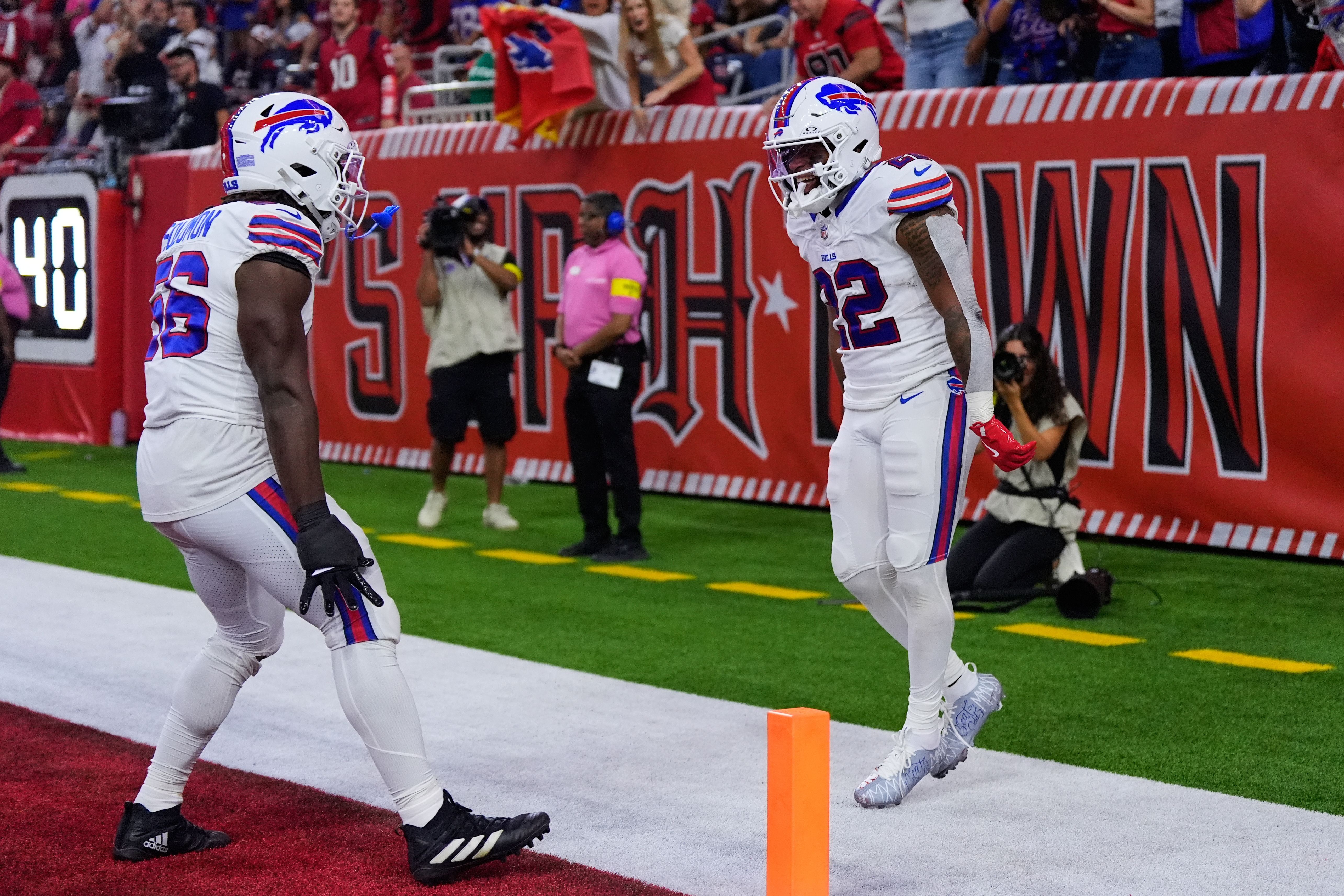 Buffalo Bills' Javon Solomon (56) and Ray Davis (22) celebrate after Davis returned a kick-off for a touchdown in the first half of an NFL football game against the Houston Texans Thursday, Nov. 20, 2025, in Houston. (AP Photo/Ashley Landis)