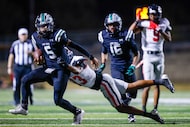 Euless Trinity Chayce Davis (13) attempts to take down Mansfield Lake Ridge DeShawn Edwards...