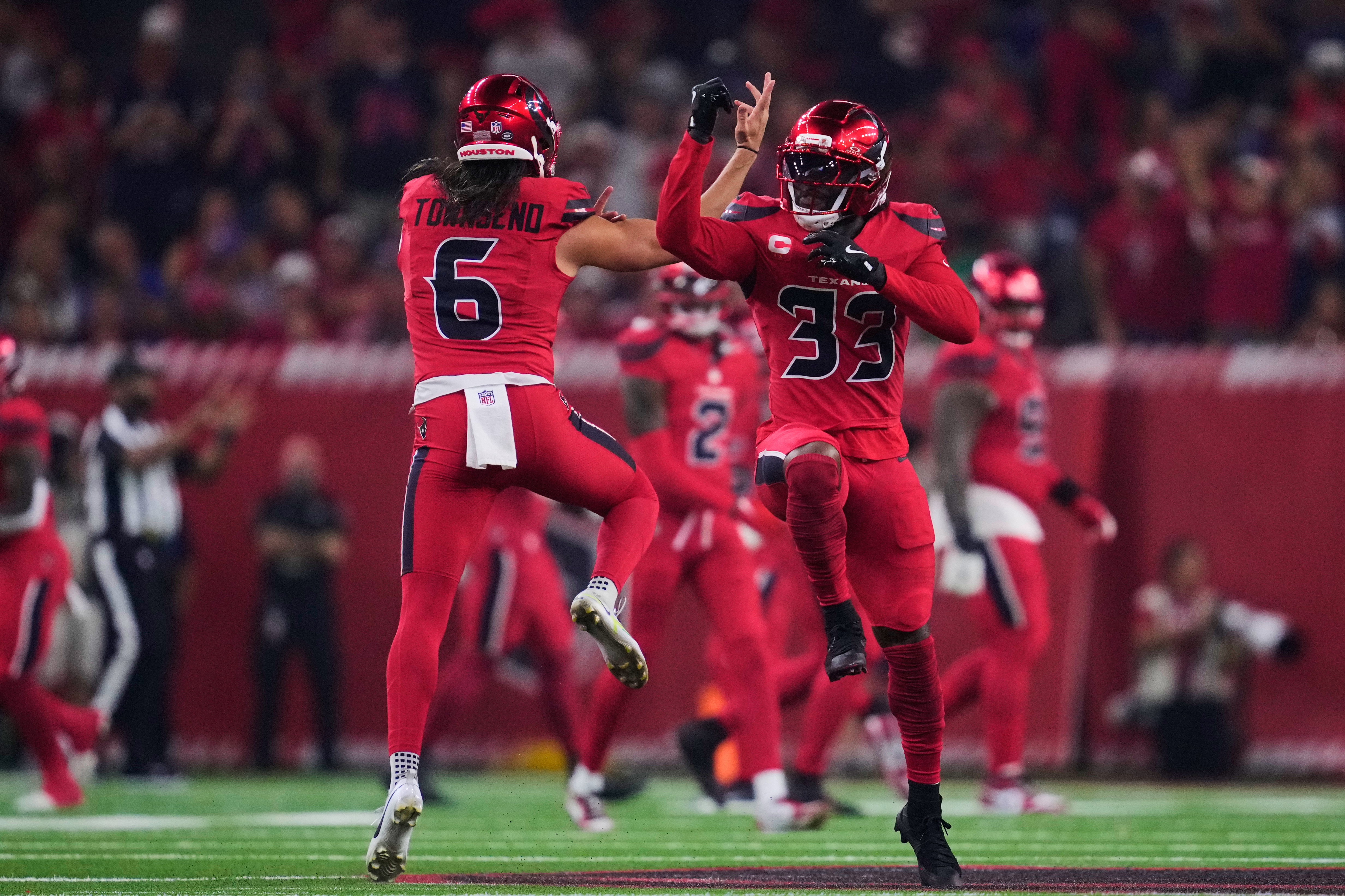 Houston Texans' Tommy Townsend (6) and Dare Ogunbowale (33) celebrate an offensive play in the first half of an NFL football game against the Buffalo Bills Thursday, Nov. 20, 2025, in Houston. (AP Photo/Ashley Landis)