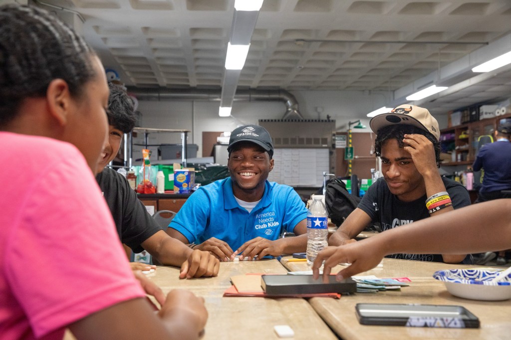 Boys & Girls Club members H’Sanii Blankenship, 17, and Ray, 16, (left to right) play Dominoes with other club members at Navarro Early College High School in Austin, Texas on July 22, 2025. Photo by Montinique Monroe for the Texas Tribune