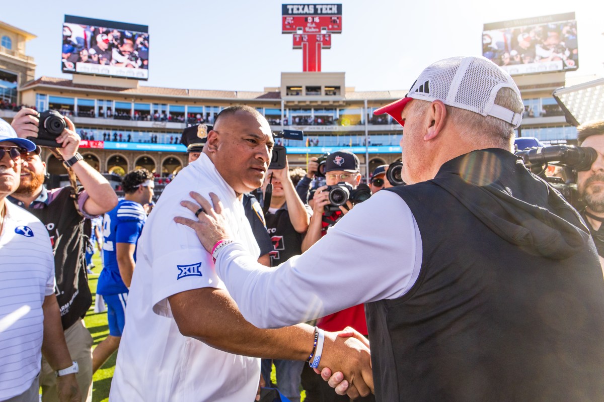 College football head Coach Kalani Sitake of the BYU Cougars shakes hands with Head Coach Joey McGuire of the Texas Tech Red Raiders