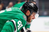 Dallas Stars center Tyler Seguin (91) talks with a Minnesota Wild player before a face-off...