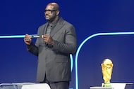 Former NBA player Shaquille O'Neal holds up the team name of Colombia during the draw for...