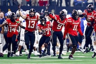 Texas Tech linebacker Ben Roberts (13) celebrates with teammates after making an...