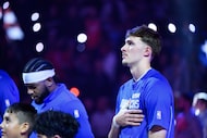 Dallas Mavericks forward Cooper Flagg, right, looks on before an NBA basketball game against...