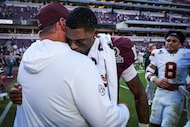 Texas A&M head coach Mike Elko embraces quarterback Marcel Reed (10) after the Aggies were...