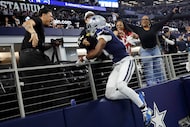 Dallas Cowboys wide receiver George Pickens (3) leaps into the suite to celebrate his second...