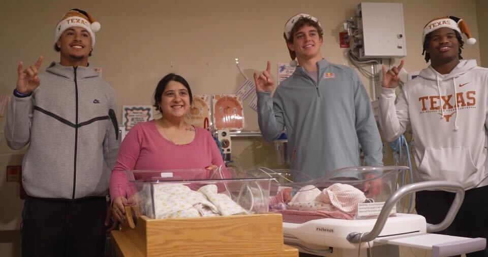 Texas football players make a surprise Austin hospital visit