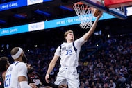 Dallas Mavericks' Cooper Flagg, right, goes up to shoot as Philadelphia 76ers' Andre...