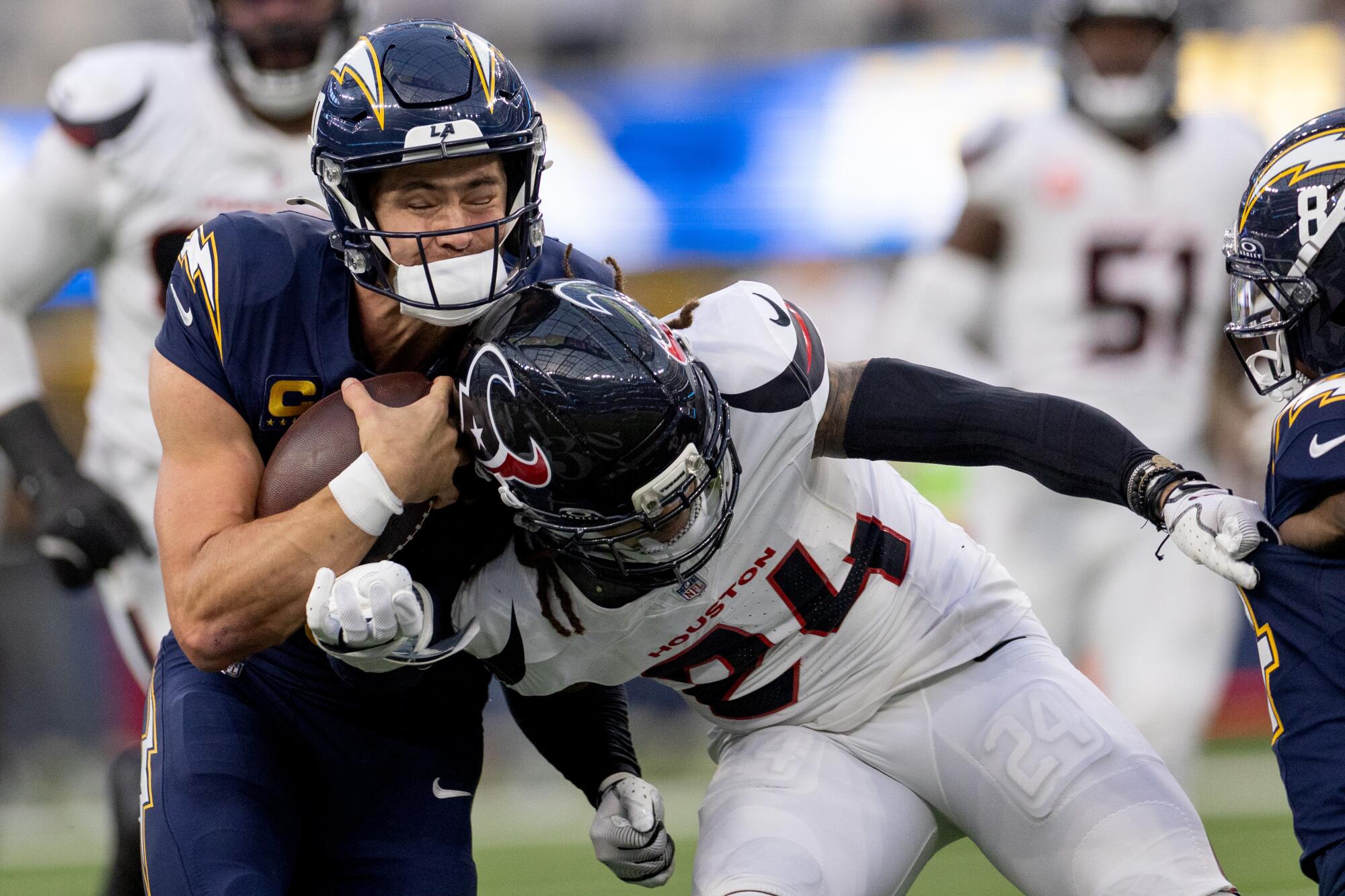 Chargers quarterback Justin Herbert is hit by Houston Texans cornerback Derek Stingley Jr.