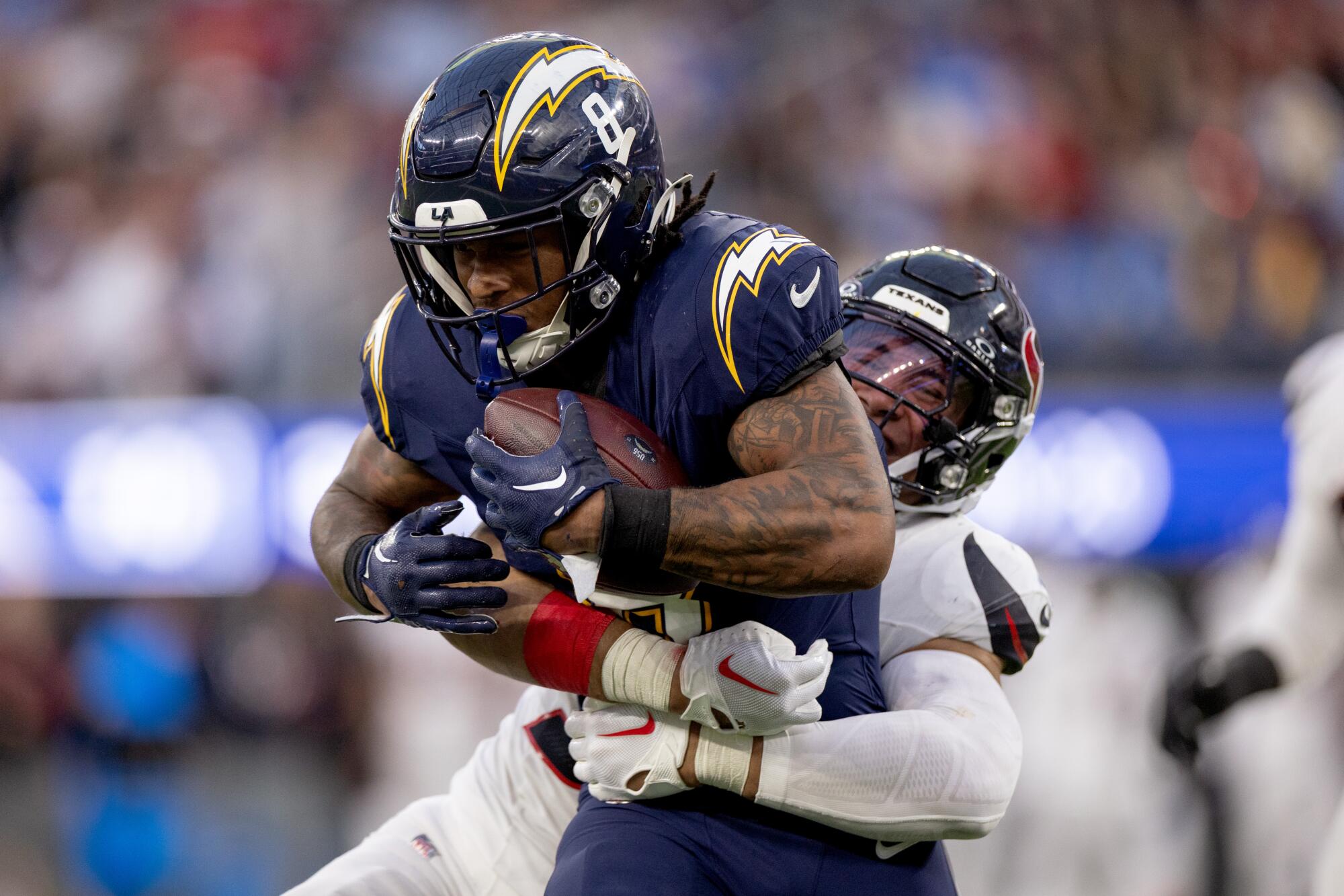 Chargers running back Omarion Hampton is tackled by Houston Texans linebacker Henry To'oTo'o during the second half.