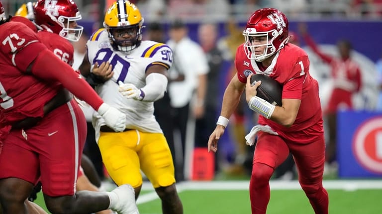 Houston quarterback Conner Weigman (1) runs the ball against LSU...