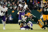 Baltimore Ravens running back Derrick Henry (22) runs the ball past Green Bay Packers...