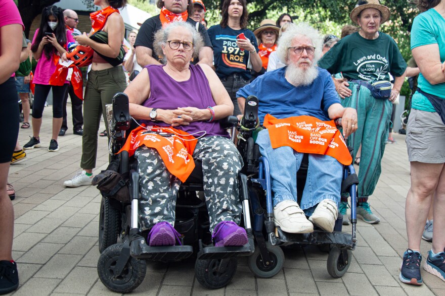 Stephanie Thomas (left) and Bob Kafka sit in wheelchairs during a protest at the Federal Courthouse in Austin after the Supreme Court’s opinion to overturn Roe v. Wade in 2022.