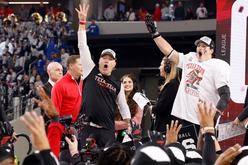 Texas Tech head coach Joey McGuire, left, Texas Tech linebacker Ben Roberts (13) celebrate...