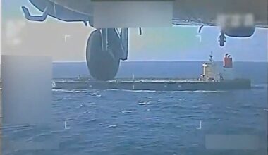 A U.S. military helicopter flies near an oil tanker during a raid described by U.S. Attorney General Pam Bondi as its seizure by the United States off the coast of Venezuela, December 10, 2025, in a still image from video