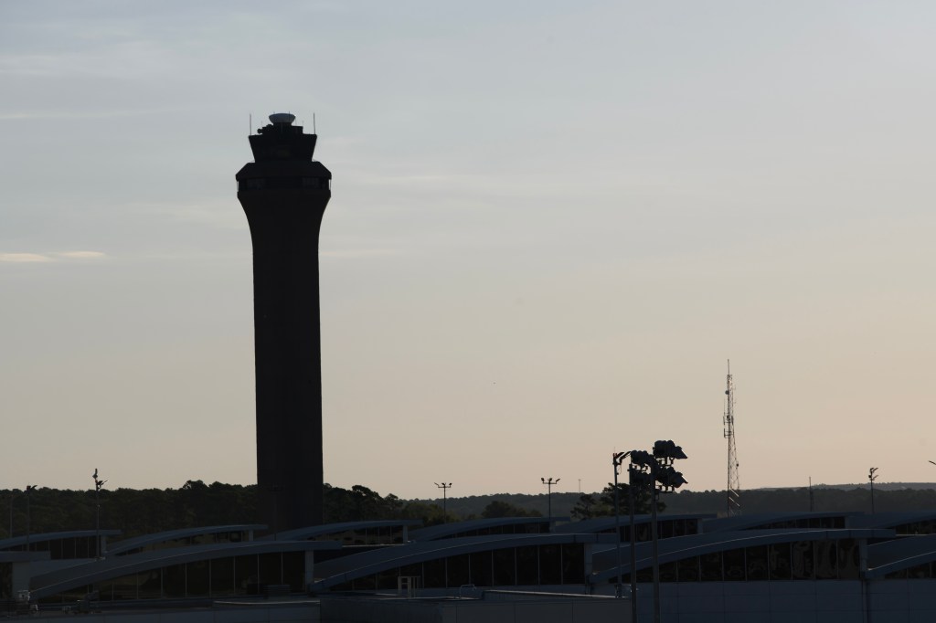 Silhouette of the Federal Aviation Administration (FAA) air traffic control tower at George Bush Intercontinental Airport (IAH).