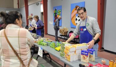 Scott Chanin helps distribute food at a “PopUp Grocery Store” hosted by the nonprofit Second Servings in Houston on Dec. 5, 2025.