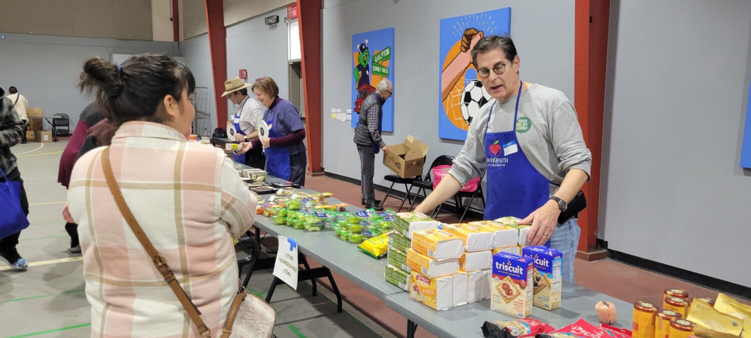 Scott Chanin helps distribute food at a “PopUp Grocery Store” hosted by the nonprofit Second Servings in Houston on Dec. 5, 2025.