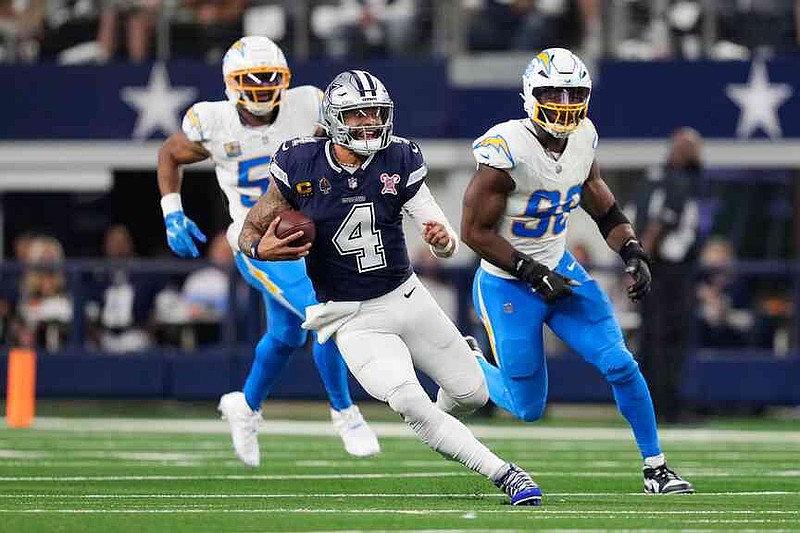 Dallas Cowboys quarterback Dak Prescott (4) runs during the second half of an NFL football game against the Los Angeles Chargers, Sunday, Dec. 21, 2025, in Arlington, Texas. (AP Photo/Tony Gutierrez)