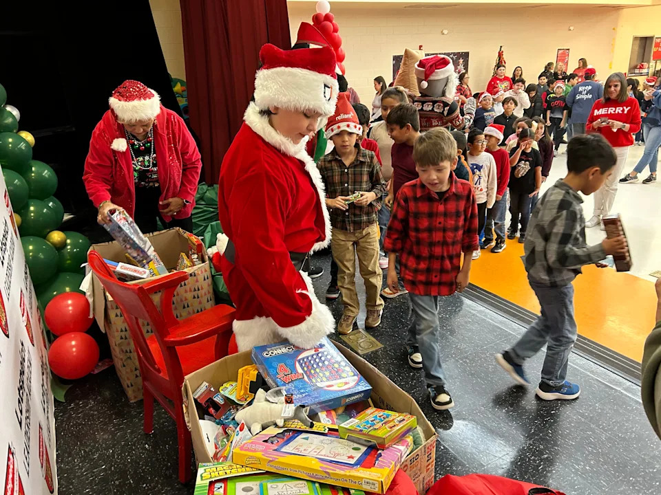 Nate Gonzalez, 12, distributes toys to every student at Lotspeich Leadership Academy Elementary School in Robstown on Dec. 16.