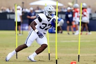 Dallas Cowboys running back Phil Mafah (37) makes a cut as he runs through obstacles during...