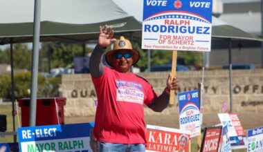 A hispanic man is seen campaigning for mayor of Schertz, Texas on a sunny afternoon.