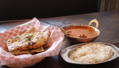 A classic lamb tikka masala dish is seen on a wooden table at a restaurant in Schertz, Texas.