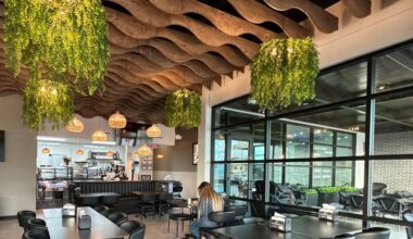 Interior of a restaurant featuring wood and botanical design elements.