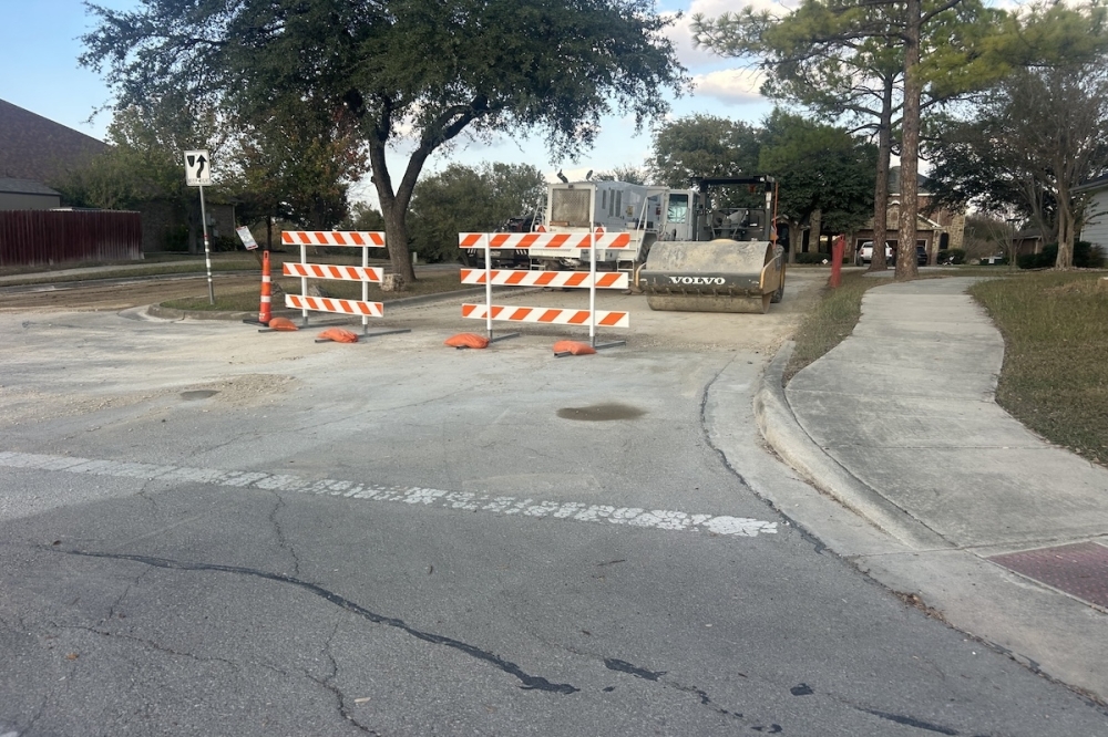 A street in Schertz, texas is seen under construction on a sunny day.