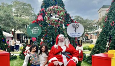 Santa with kids in front of a Christmas tree