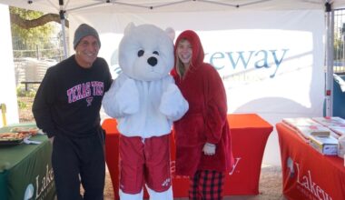 man and girl standing with person in polar bear costume