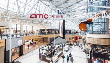 Interior of a two-story mall featuring glass and beam celings.
