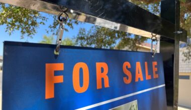 For sale sign in front of house