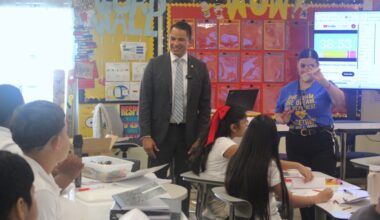 The superintendent talks to middle school students in a classoom