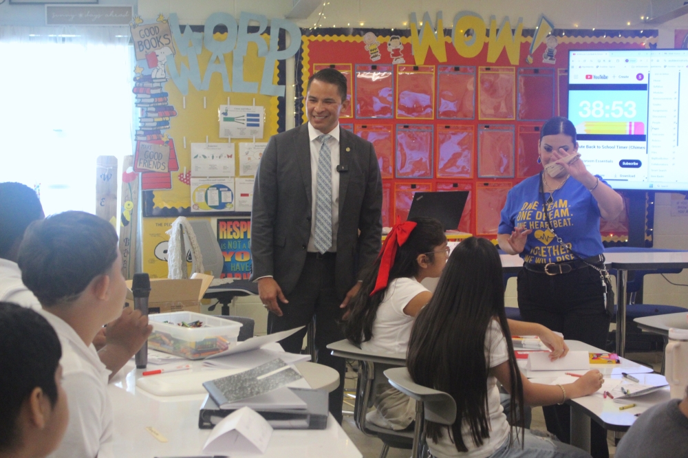 The superintendent talks to middle school students in a classoom