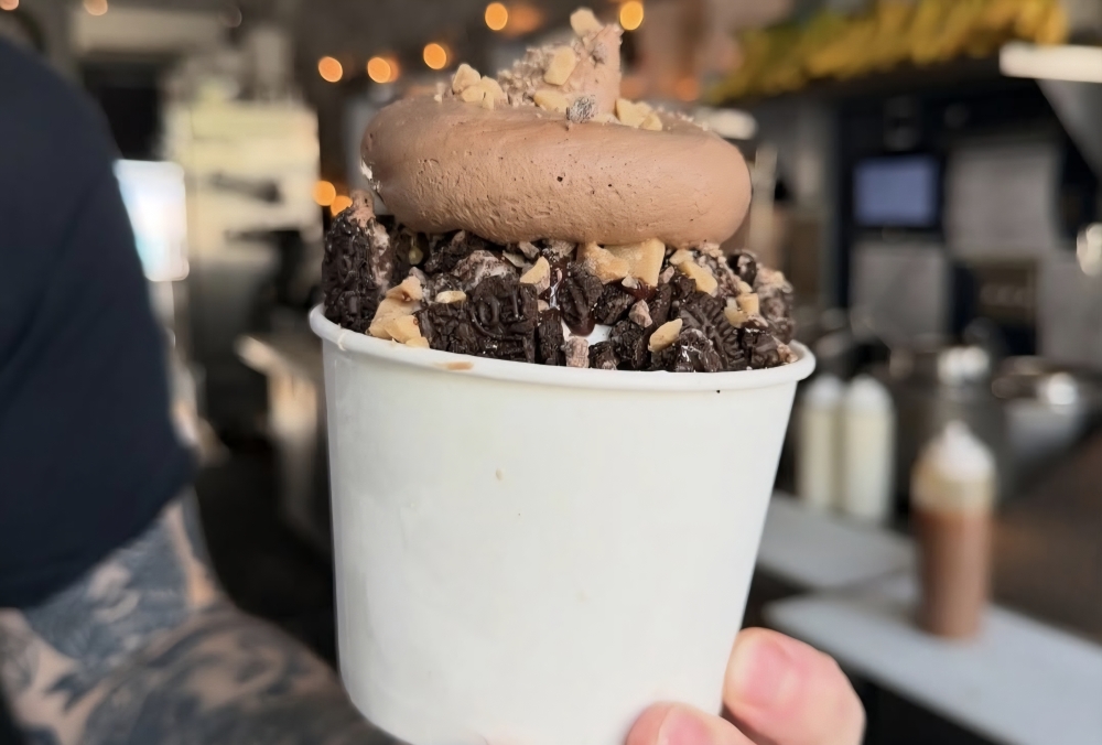 Scoop N Scootery offers an ice cream sundae topped with chocolate mousse.